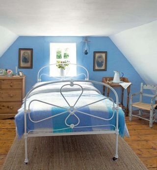 Blue bedroom in thatched Irish cottage