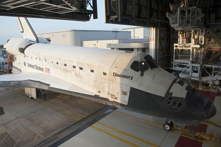 Space shuttle Discovery rolls March 9, 2011 into Kennedy Space Center’s Orbiter Processing Facility-2 in Florida after its final mission STS-133. It will be readied for retirement and public display. 