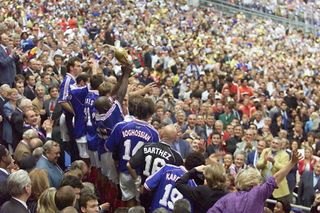 France players celebrate with the World Cup trophy after victory in the final against Brazil at the Stade de France in July 1998.