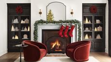 Living room decorated for Christmas with red accent chairs
