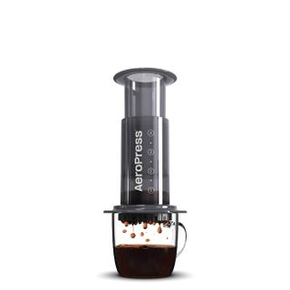 A black AeroPress coffee maker on a white background