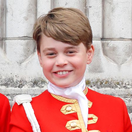 Prince George wears red uniform with gold adornments