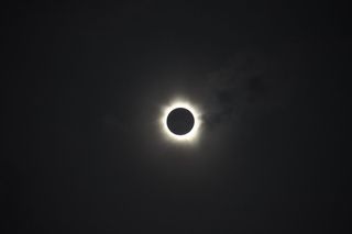 The total solar eclipse of November 13-14,2012. The clouds cleared in time for observers at Palm Cove, Australia, to experience totality as the Moon totally obscured the Sun for around two minutes, revealing the Sun's bright corona.