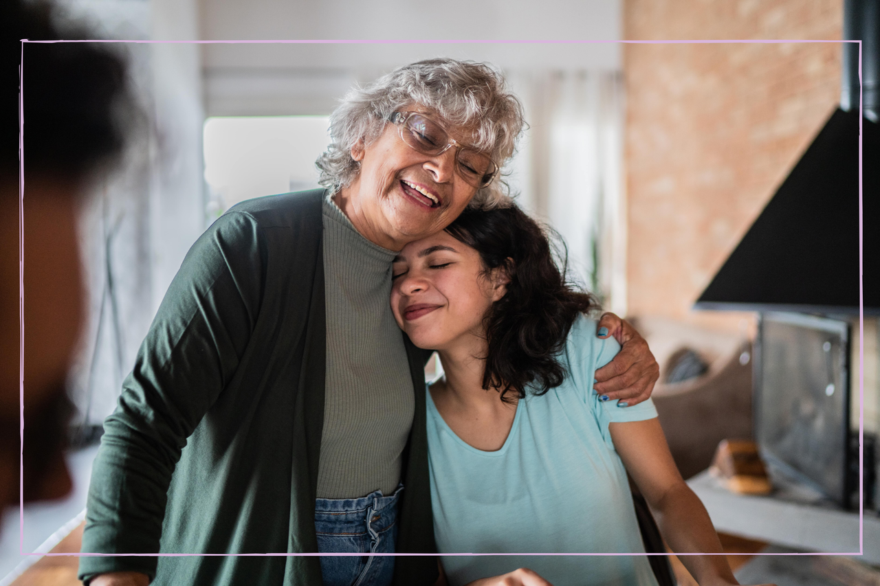 Grandmother embracing granddaughter at home