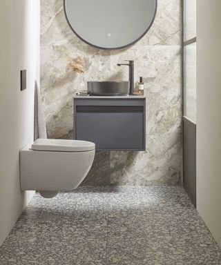 concrete effect bathroom flooring in small cloakroom