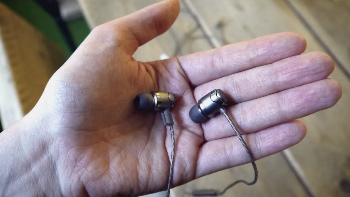 SoundMagic E11C held in a hand