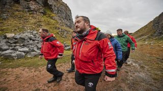 A training exercise shows mountain rescue team carrying a stretcher in a quarry