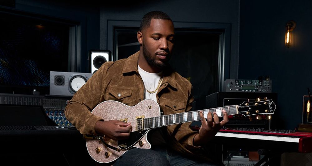 Man playing a Gretsch electric guitar