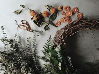 A wreath being made with eucalyptus, cinnamon and dried oranges