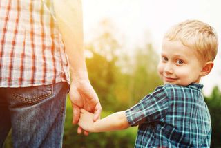 man holding young boy's hand