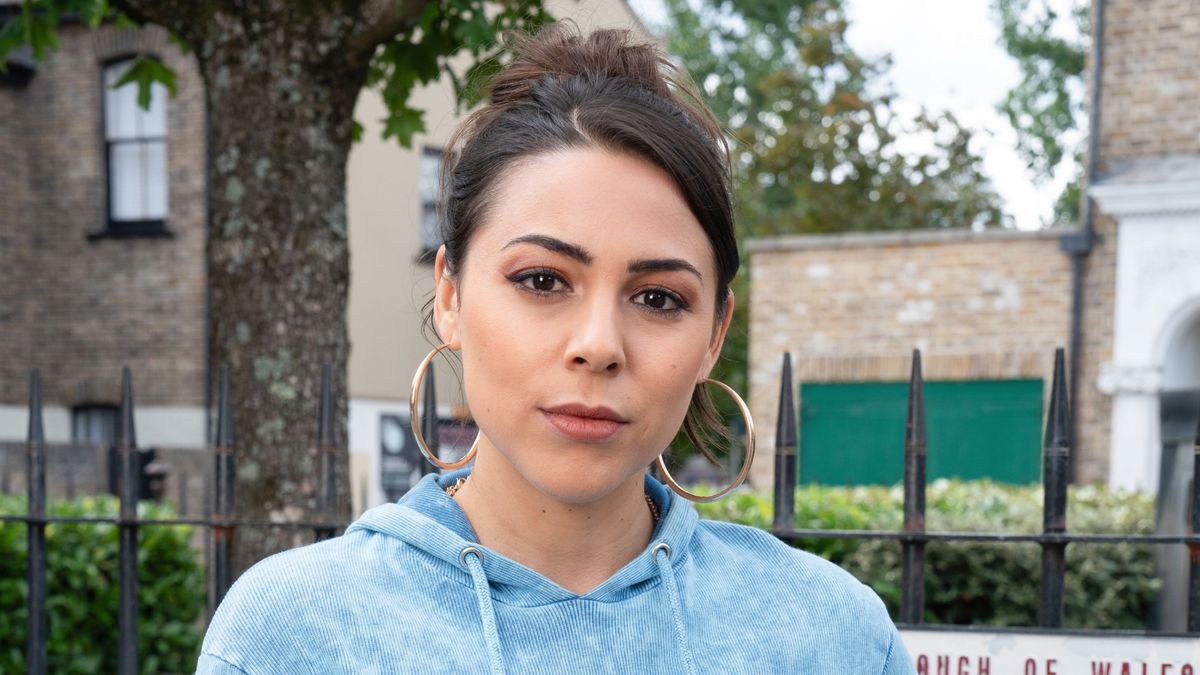 Priya Nandra-Hart wearing large hoop earrings and a blue hoodie.