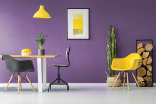 A purple and yellow themed room with a small dining set