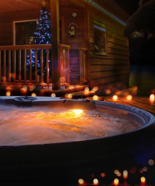 hot tub in winter surrounded by fairy lights