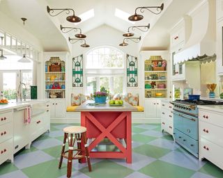 French country kitchen with red island and blue and green check flooring