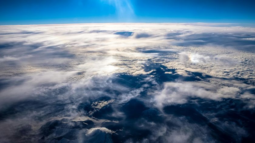 a photograph of Earth&#039;s surface taken from above the clouds