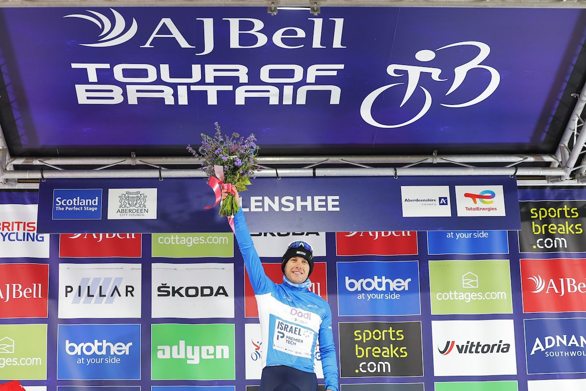Picture by Alex WhiteheadSWpixcom 04092022 Cycling 2022 AJ Bell Tour of Britain Stage 1 Aberdeen to Glenshee Ski Centre Scotland Corbin Strong of Team Israel Premier Tech on the podium taking the Doll by AJBell Points Jersey
