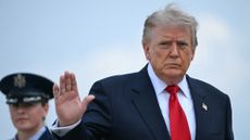 US President Donald Trump waves as he boards Air Force One