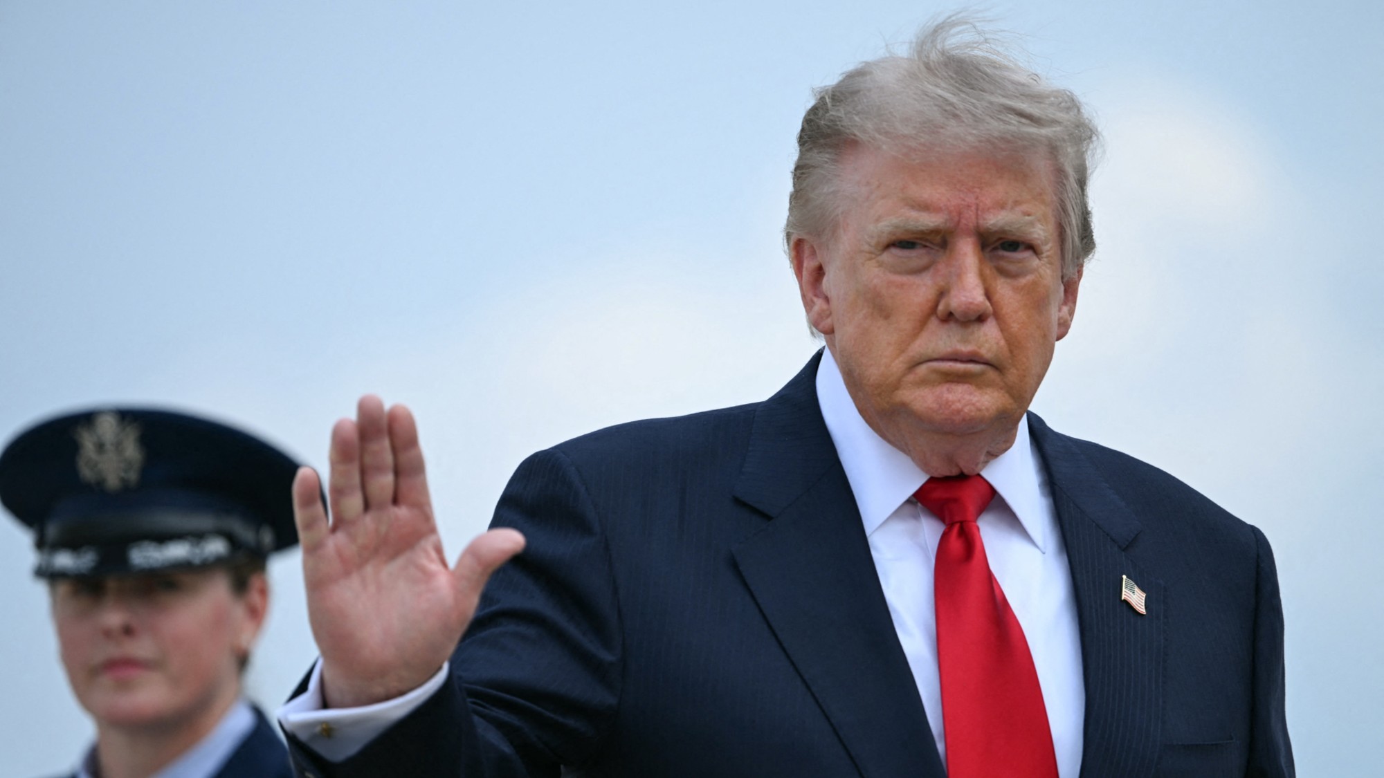 US President Donald Trump waves as he boards Air Force One