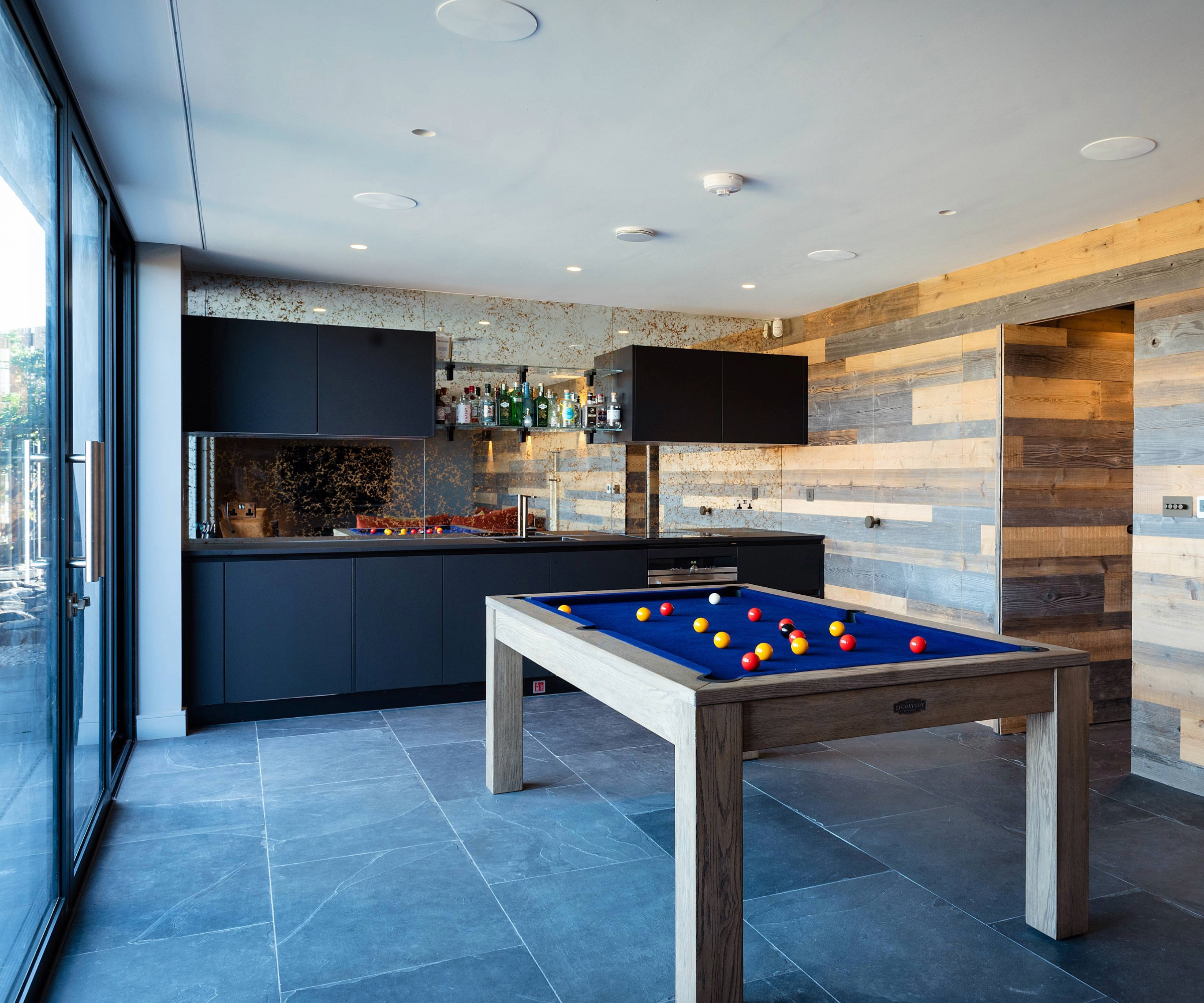 Games room with pool table and bar