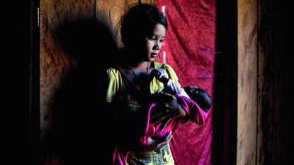 Teenage mother and baby in Cambodia