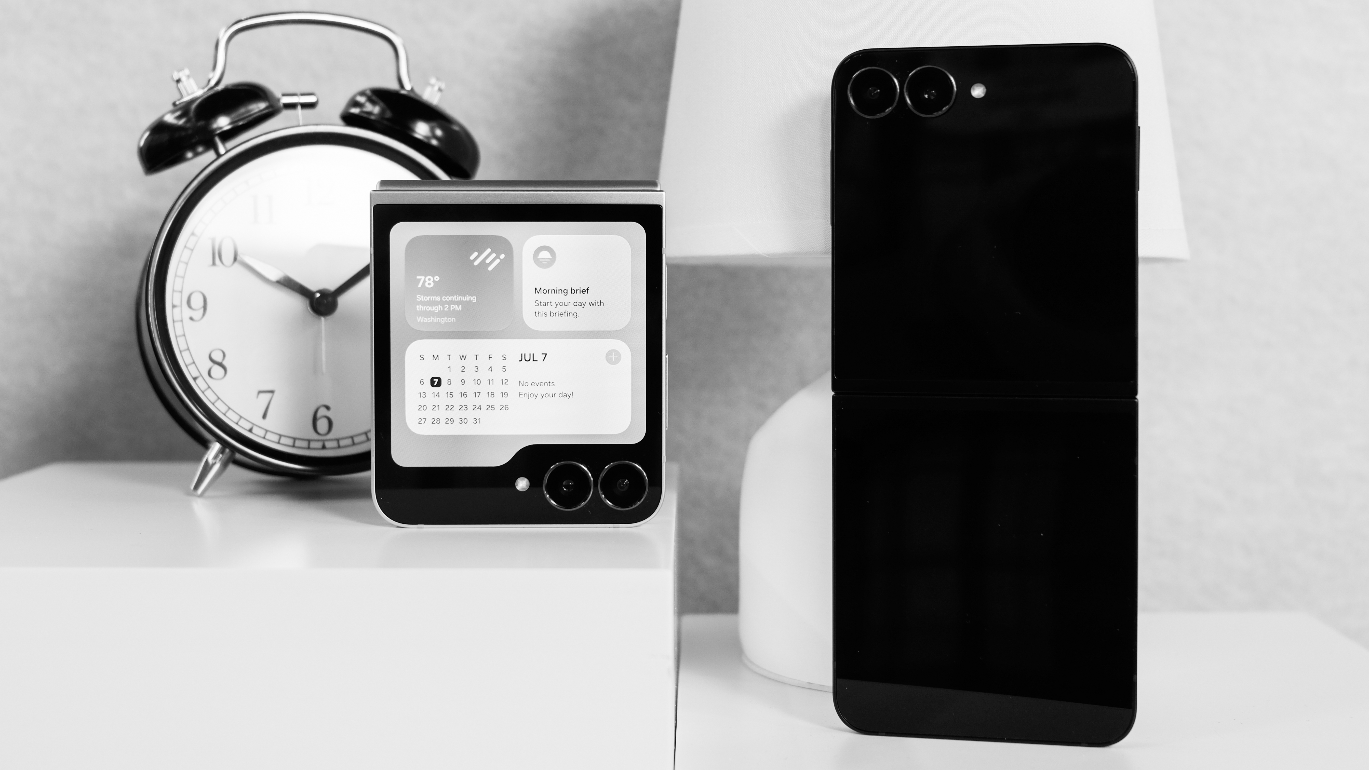 Samsung Galaxy Z Flip 7 FE closed with widgets on the cover screen and open showing the back of a black Flip 7 FE