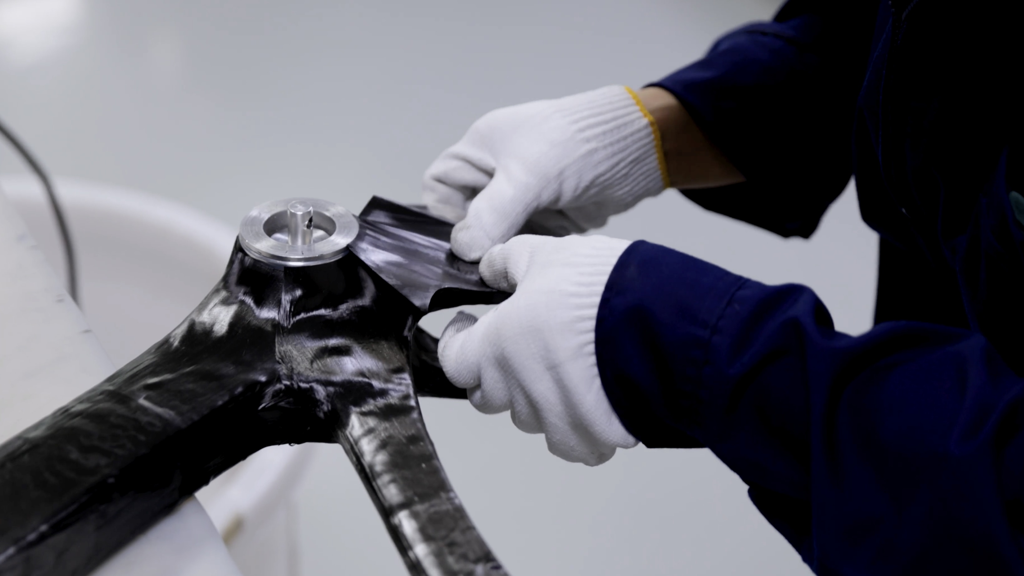 XDS Factory, raw carbon frame being assembled by workers