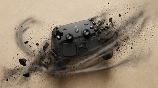 A black gaming controller shatters dramatically against a beige background, surrounded by swirling debris, conveying motion and intensity.