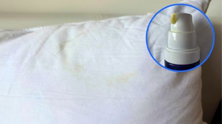A pillow with a yellow retinol stain. In the top right foreground, there is a circular frame featuring a pump bottle of retinol serum. 