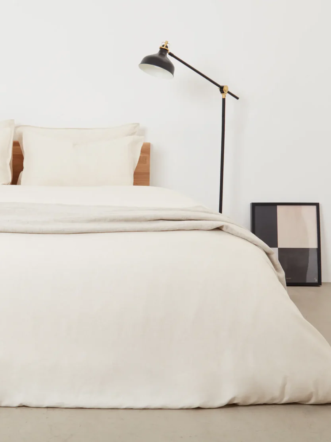 A minimalist bed with natural bedding