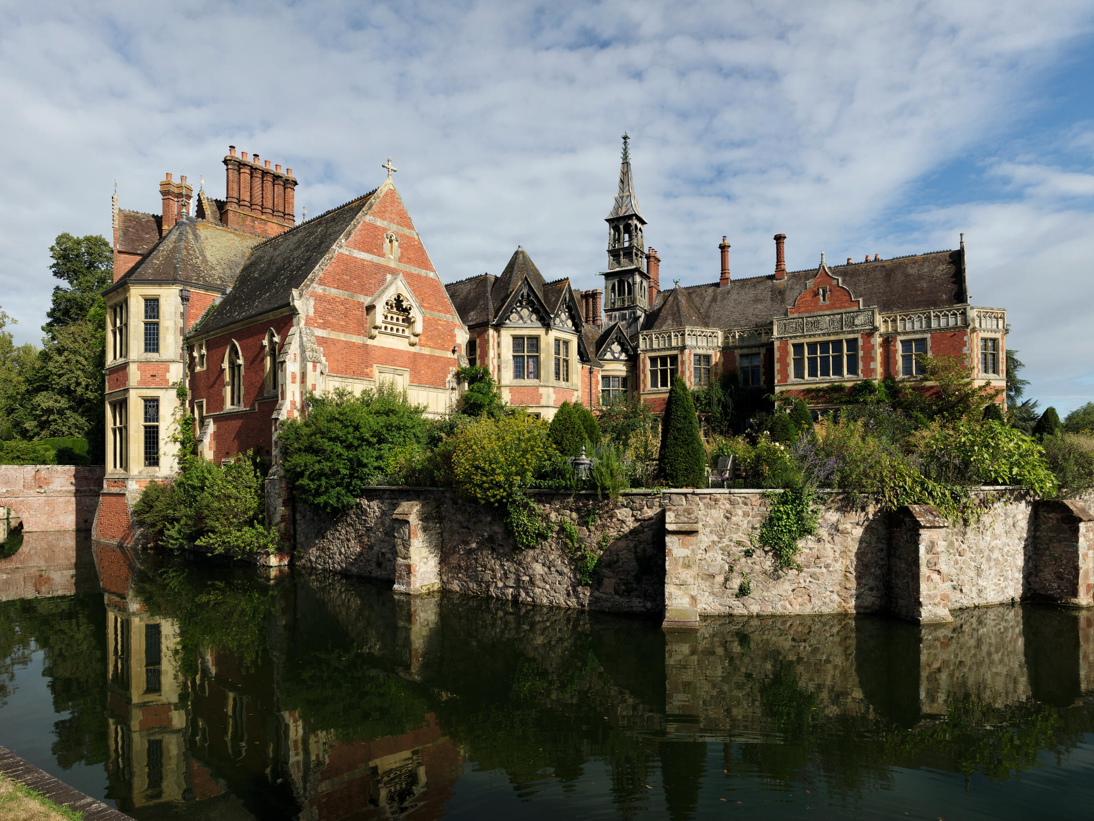 Fig 1: The moated east front of Madresfield Court, with the 1860s chapel (left) and drawing room (right) on the site of the Regency wing.