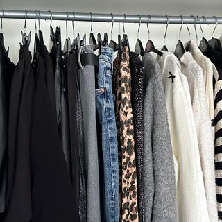 White wardrobe with jumpers and jeans hung up