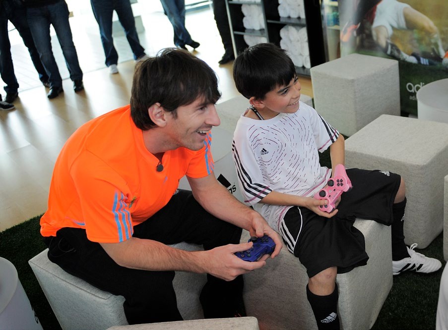 BARCELONA, SPAIN - JANUARY 13: Lionel Messi plays playstation during the launch of the new adiZero footwear range from adidas on January 13, 2011 in Barcelona, Spain. (Photo by David Ramos/Getty Images for adidas)