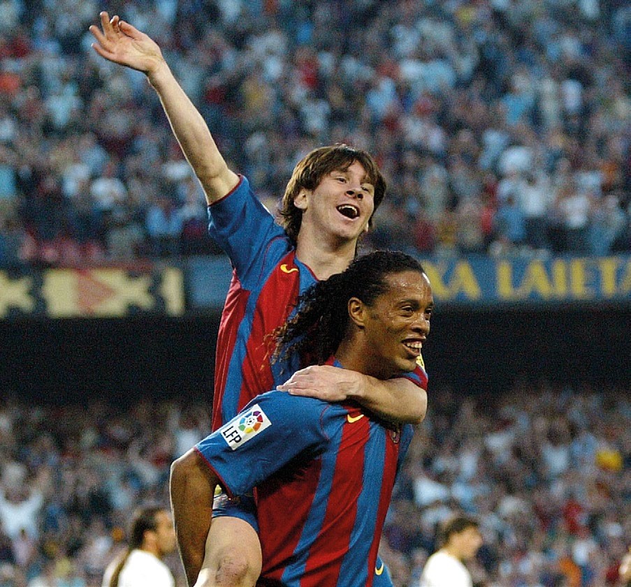 BARCELONA, SPAIN: FC Barcelona's Argentinian Messi (up) and Brazilian Ronaldinho celebrate their second goal against Albacete during their Spanish League football match at the Camp Nou stadium in Barcelona, 01 May 2005. FC Barcelona won 2-0. AFP PHOTO/LLUIS GENE. (Photo credit should read LLUIS GENE/AFP via Getty Images)