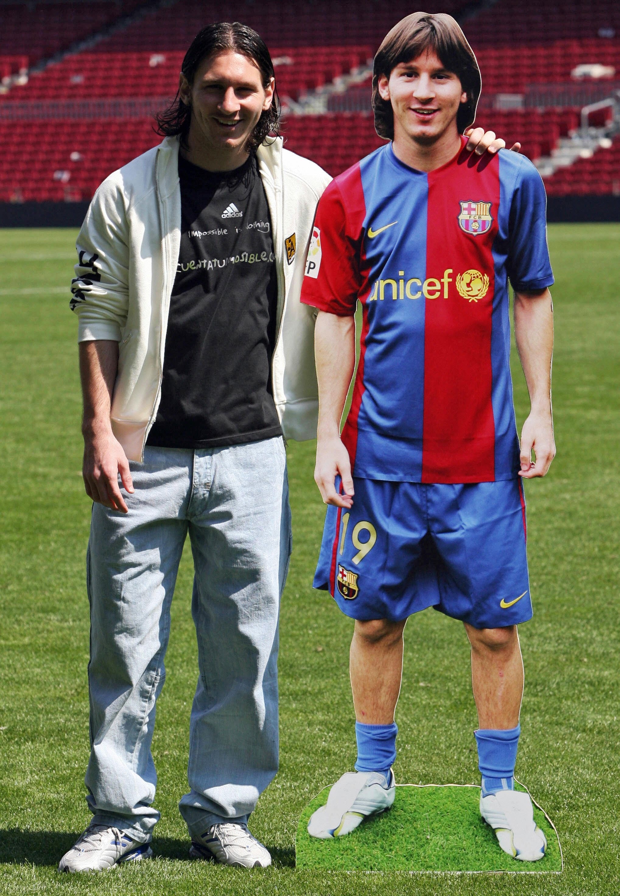 Barcelona, SPAIN: FC Barcelona's Argentinian Leo Messi poses with his portrait at Camp Nou stadium, 19 April 2007, in Barcelona. Messi scored yesterday against Getafe a historical goal, like Maradona's World cup goal in 1986 against England. AFP PHOTO/LLUIS GENE. (Photo credit should read LLUIS GENE/AFP via Getty Images)