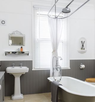 bathroom with white and grey wall bathtub and wash basin