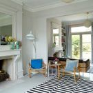 living room with monochrome rug and floor lamp