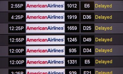 A board shows delayed American Airlines flights at Miami International Airport on April 16.