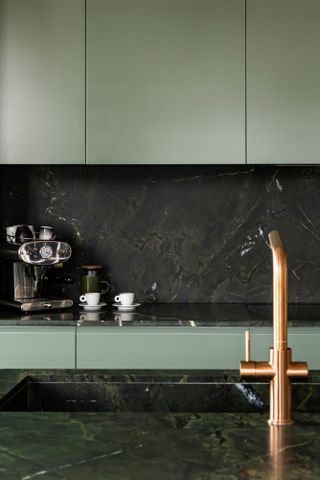 green kitchen with black marble