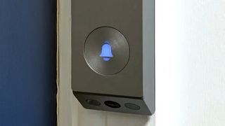 EZVIZ EP3x Pro video doorbell mounted beside blue door