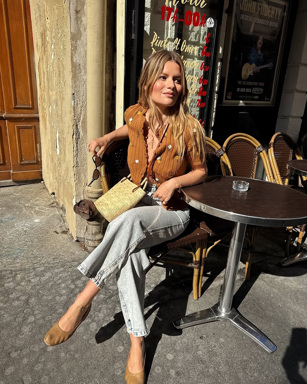 Woman wearing cropped jeans and ballet flats.