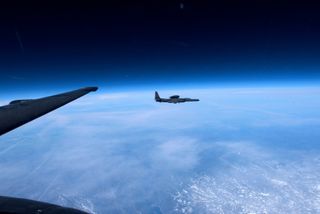 A U-2 spy plane flying at high altitude with the blackness of space above.