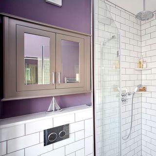bathroom with metro tiles and cabinet