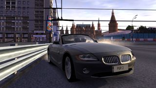 Best original Xbox games – Project Gotham Racing 2 screenshot of a car driving down a road with a cityscale behind it.