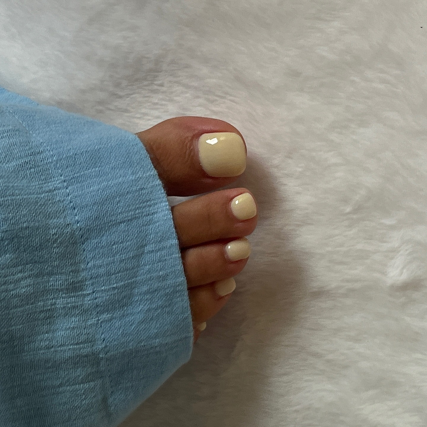 A picture of a lemon yellow pedicure