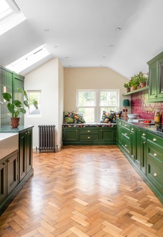 Green kitchen with parquet flooring