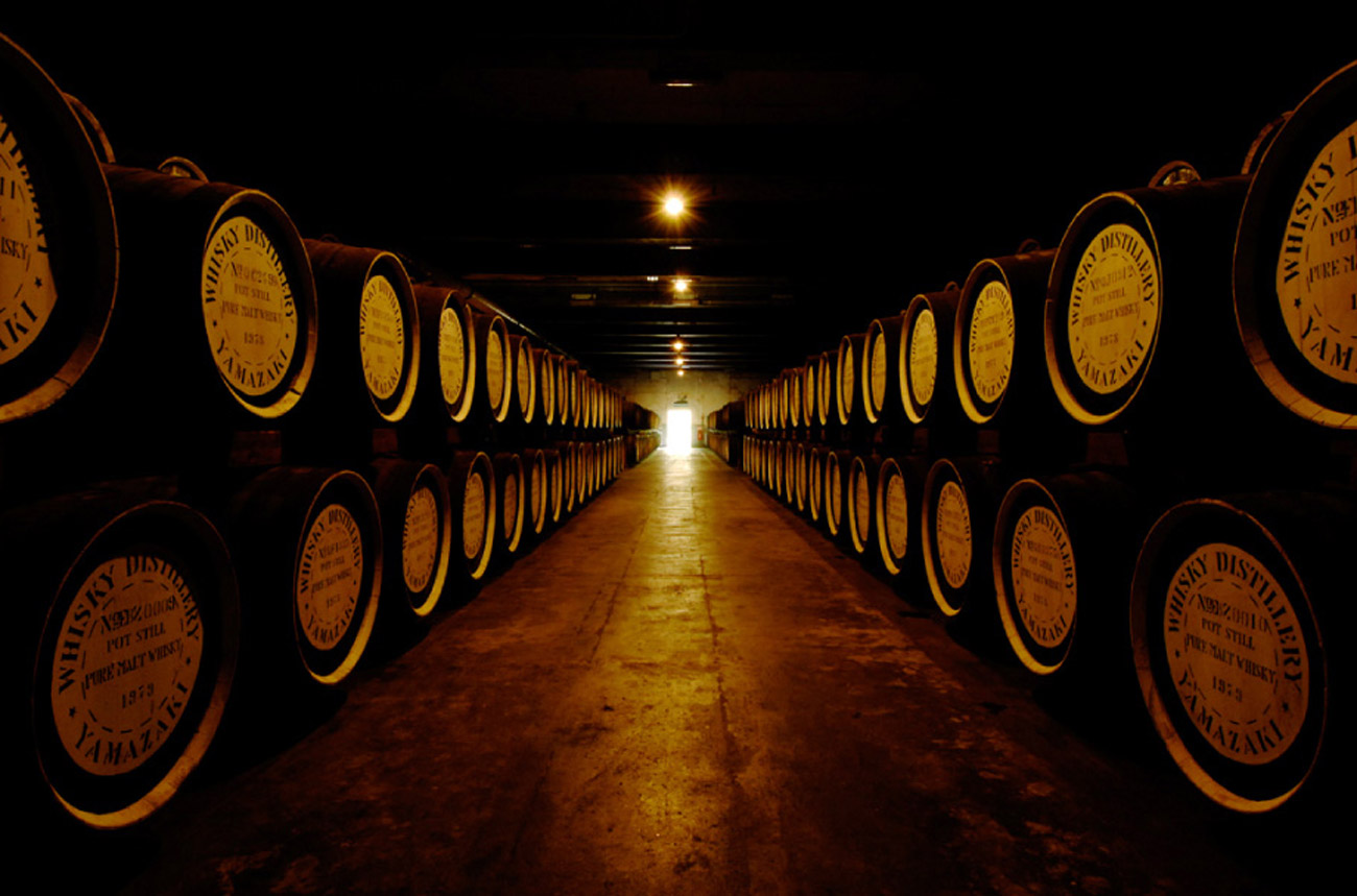 Two rows of whisky barrels in a cellar