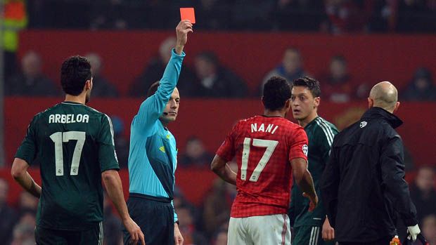 Turkish referee Cuneyt Cakir (2L) shows Manchester United&amp;#039;s Portuguese midfielder Nani (3R) the red card to send him off during the UEFA Champions League round of 16 second leg football match