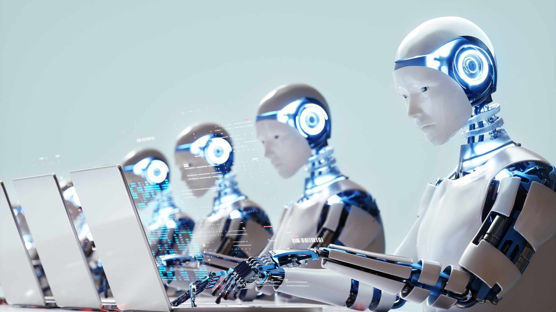 robots working on laptops