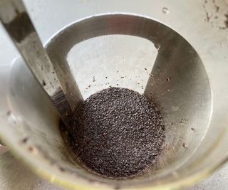 The GroundsLifter pulling old grounds up from the bottom of the French press