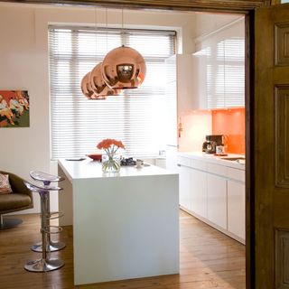 kitchen area with white worktop and hanging lights